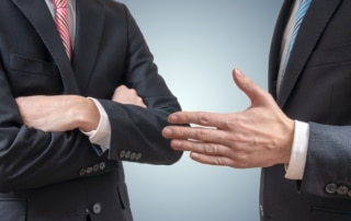 Handshake refuse. Man is refusing shake hand with businessman who is offering hand.